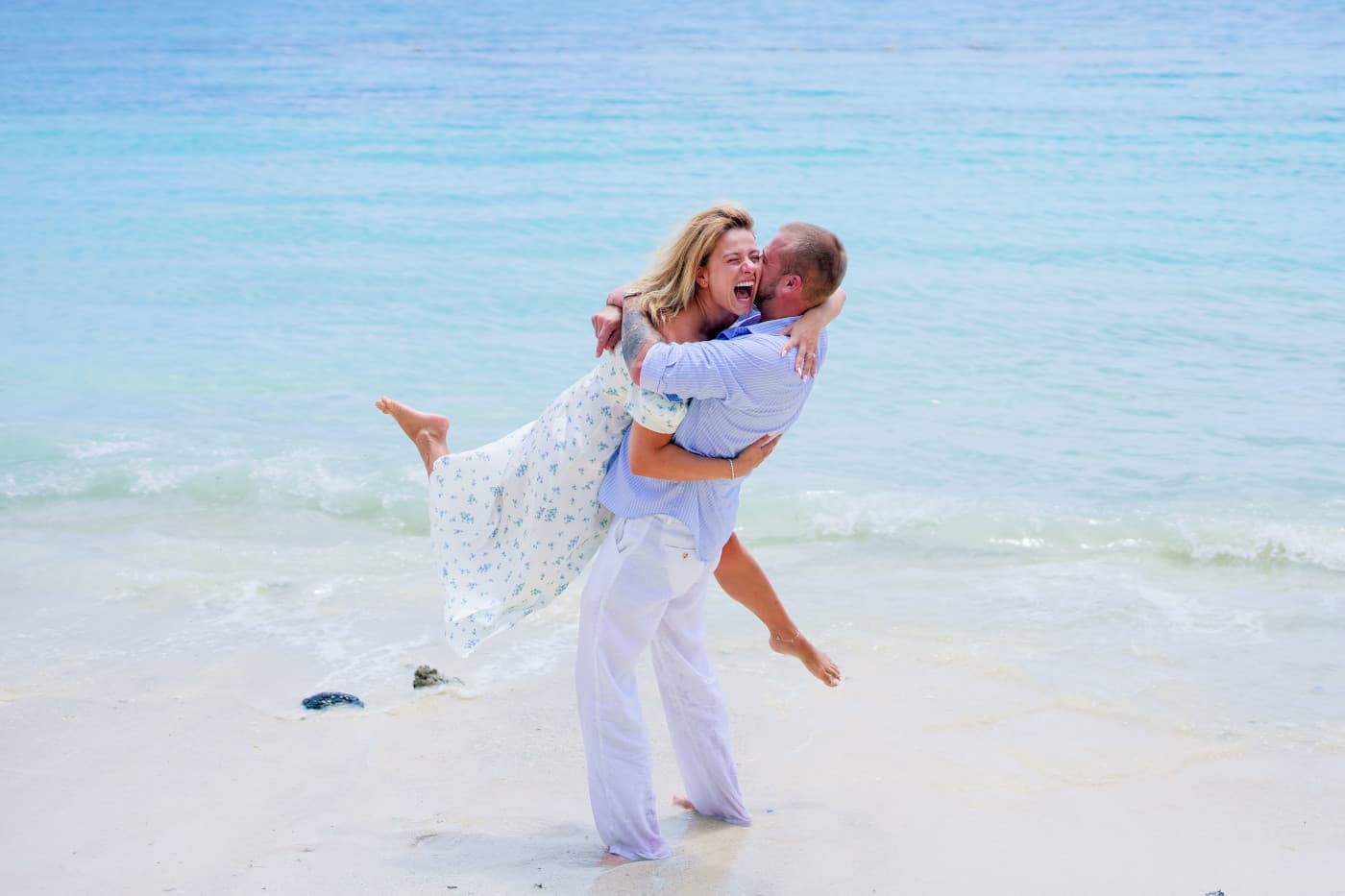 Couple laughing during a private beach photoshoot at Bain Boeuf in Mauritius