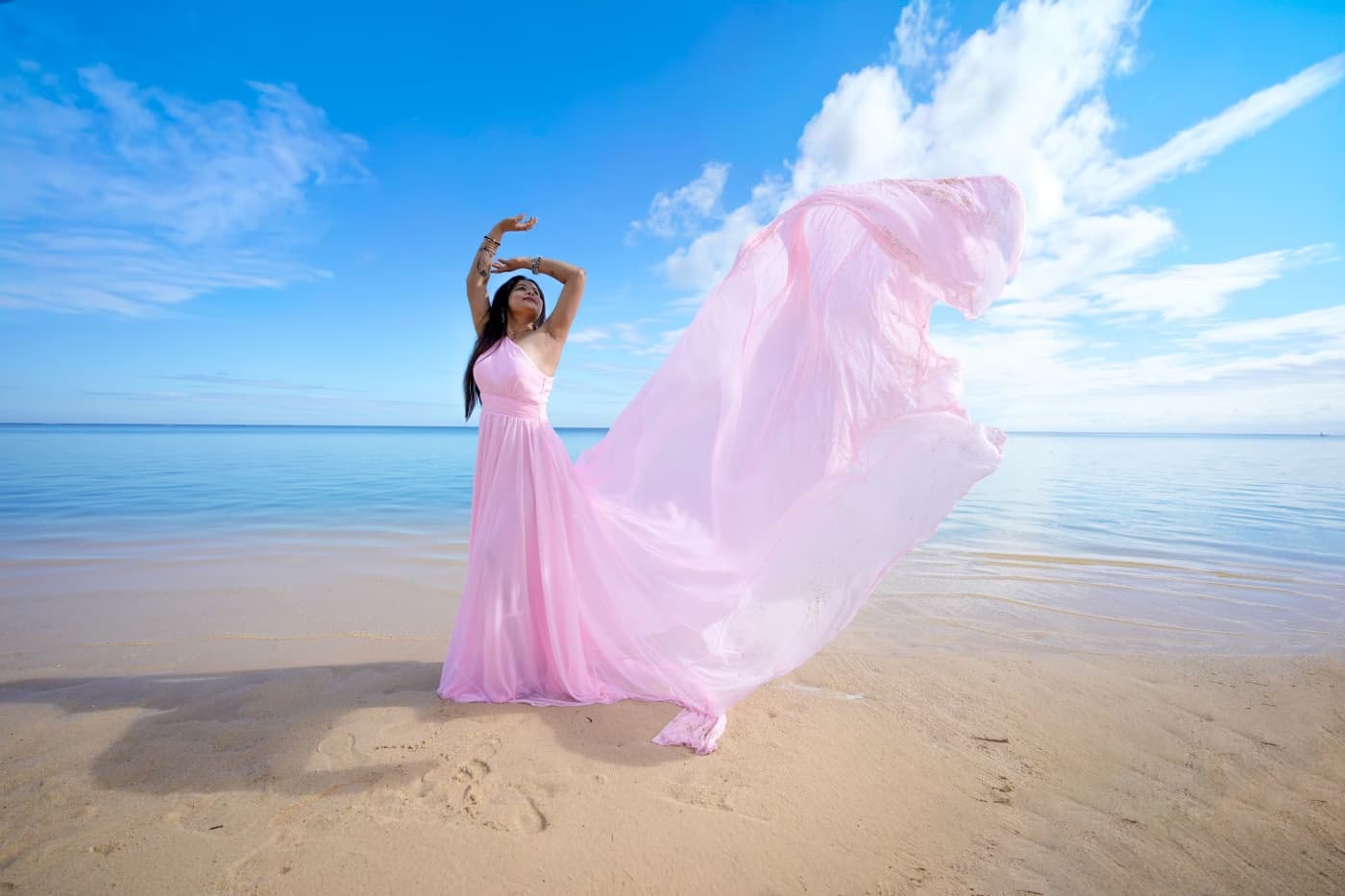 Beach photoshoot in Mauritius with a flowing pink dress