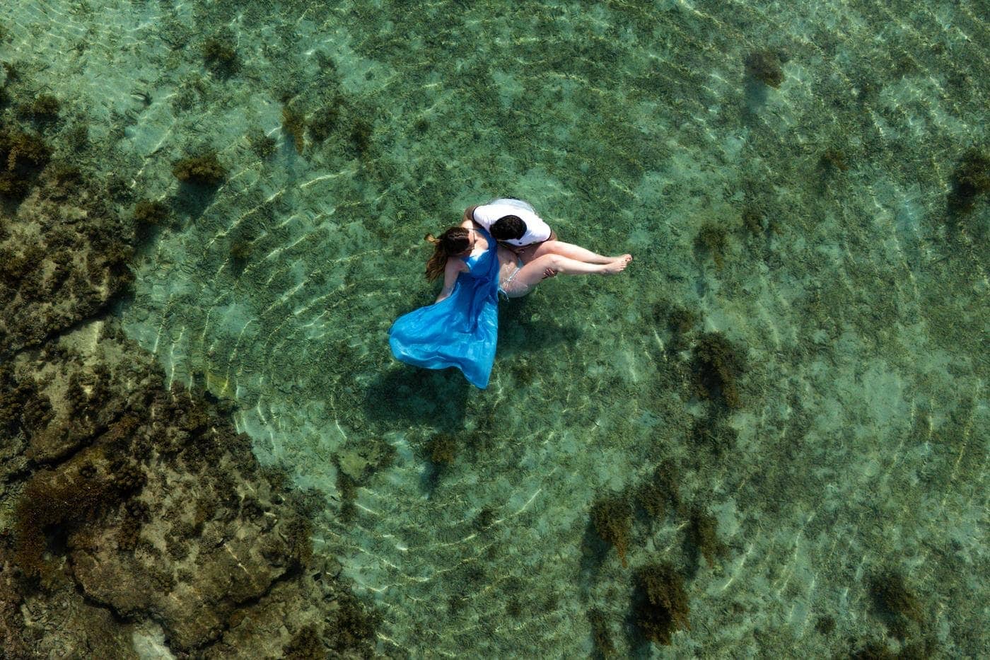 Aerial couple embracing turquoise lagoon mauritius