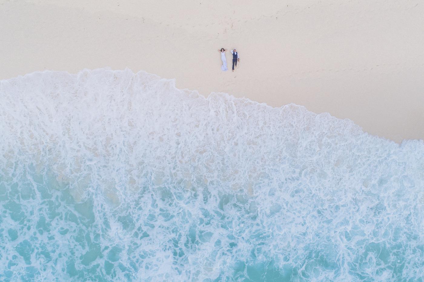 Aerial tiny couple wide ocean surf mauritius