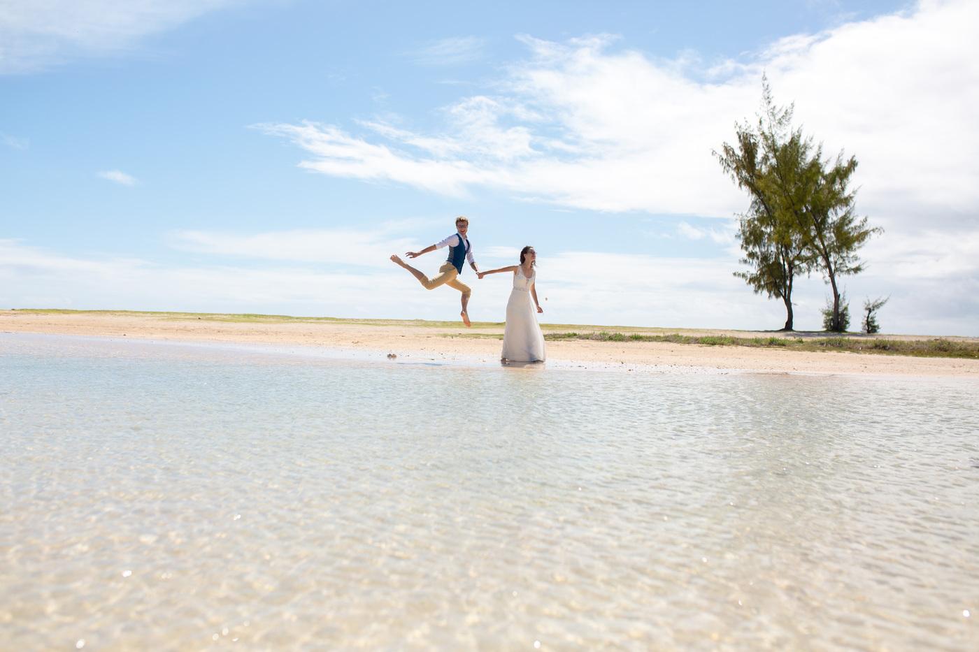 Couple walking shallow lagoon beach mauritius