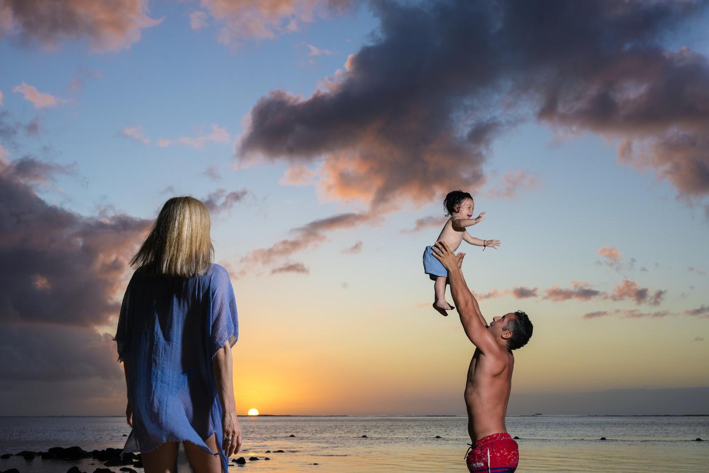 Family sunset father lifting child beach mauritius