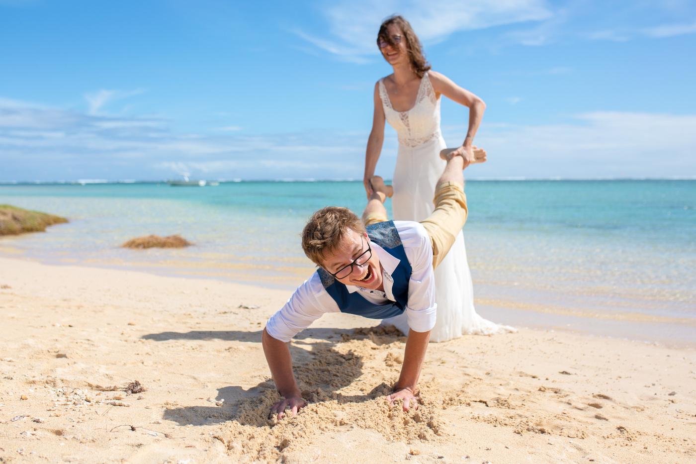 Playful groom push ups bride on beach mauritius