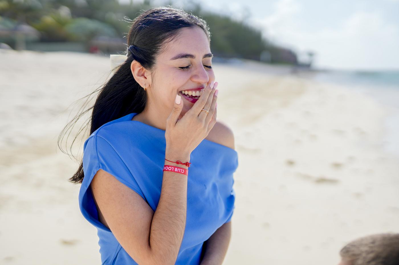Surprised woman blue dress beach proposal mauritius
